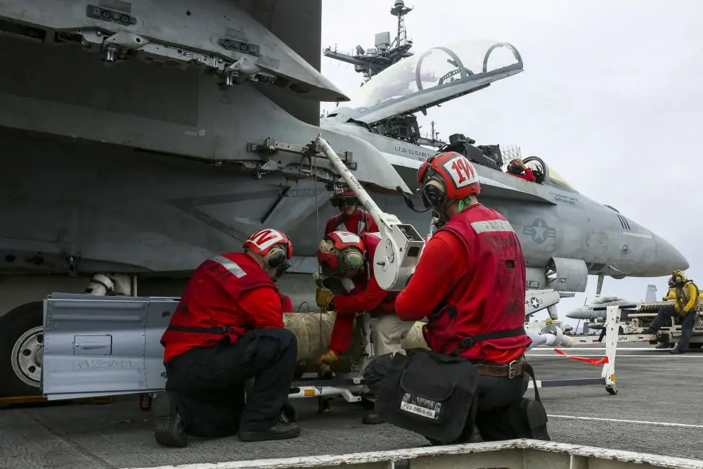 Sailors, assigned to the "Black Aces" of Strike Fighter Squadron (VFA) 41, load a GBU-16 laser guided bomb onto an F/A-18F Super Hornet on the flight deck of the Nimitz-class aircraft carrier USS Abraham Lincoln (CVN 72). 