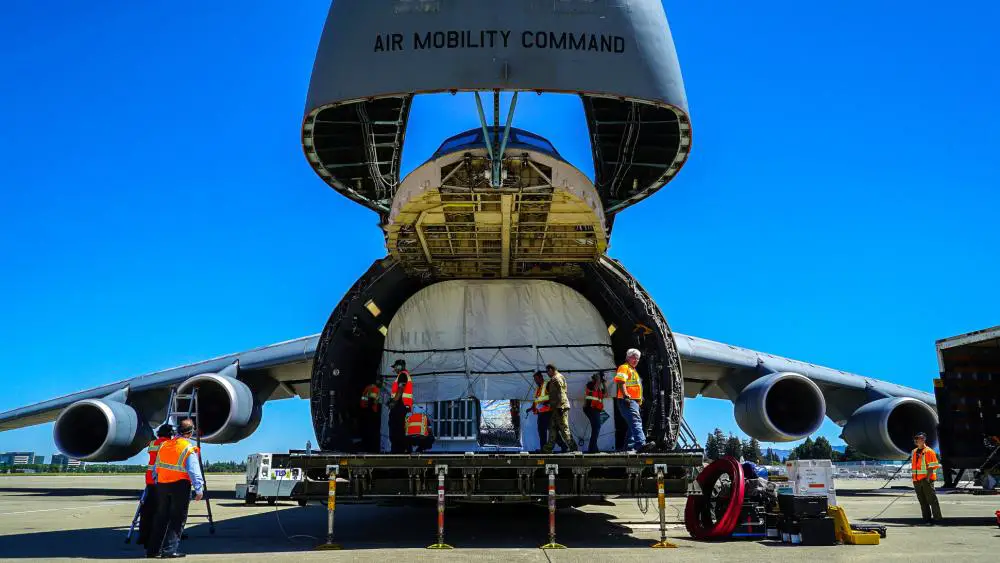 Loadmasters from the 60th Air Mobility Wing and Lockheed Martin Space load the sixth Geosynchronous Earth Orbit Space Based Infrared System satellite (SBIRS GEO-6) into a C-5M Super Galaxy aircraft at Moffett Federal Airfield, Calif.