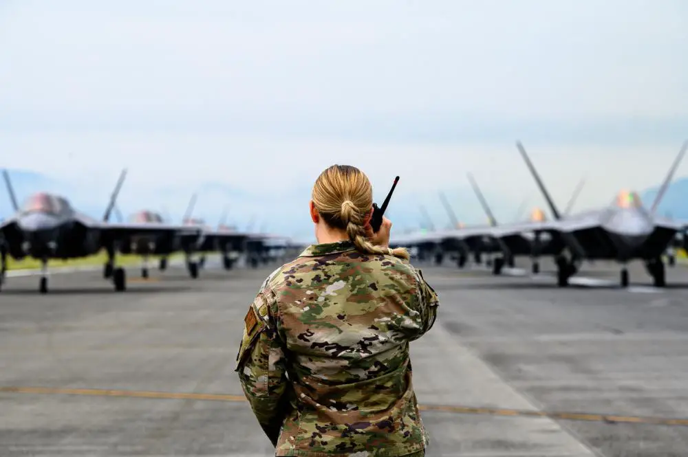 U.S. Air Force Capt. Faith Hirschmann, the 354th Air Expeditionary Wing chief of Public Affairs, listens to the radio during a pre-planned readiness exercise at Marine Corps Air Station Iwakuni, Japan, July 7, 2022. 