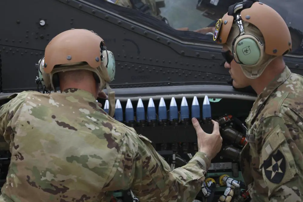 Soldiers assigned to 5-17 Air Cavalry Squadron, 2nd Combat Aviation Brigade, 2nd Infantry Division, load 30mm rounds into the AH-64E Apache Helicopter, July 19, 2022, Rodriguez Live Fire Complex, Republic of Korea
