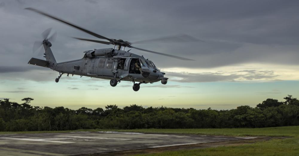 A U.S. Navy Sikorsky SH-60 Seahawk Helicopter with Helicopter Sea Combat Squadron 85 ascends from a helicopter pad after an aerial sniper training during an Urban Sniper Course on Camp Schwab, Okinawa, Japan, June 15, 2022.