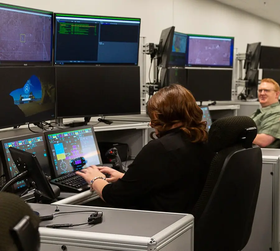 An MQ-25 program engineer demonstrates the functionality of the MD-5 Ground Control Station (GCS) at the System Test and Integration Lab (STIL) at Pax River. The MQ-25 team conducted its first lab integration event in June 2022 at the STIL to demonstrate how the GCS will command the MQ-25 air vehicle in the carrier environment.