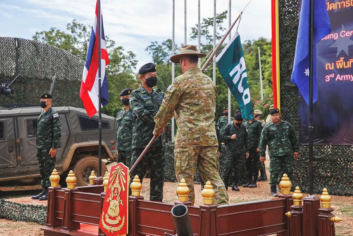 Major General Suriya Eiamsulo, 3rd Army Area Deputy Commander, hands the Rifle Company Butterworth pennant to Defence Attache to Thailand, Colonel Stephen Fomiatti, during the closing ceremony of Exercise Chapel Gold 2022 in Nakhon Sawan Province, Thailand.