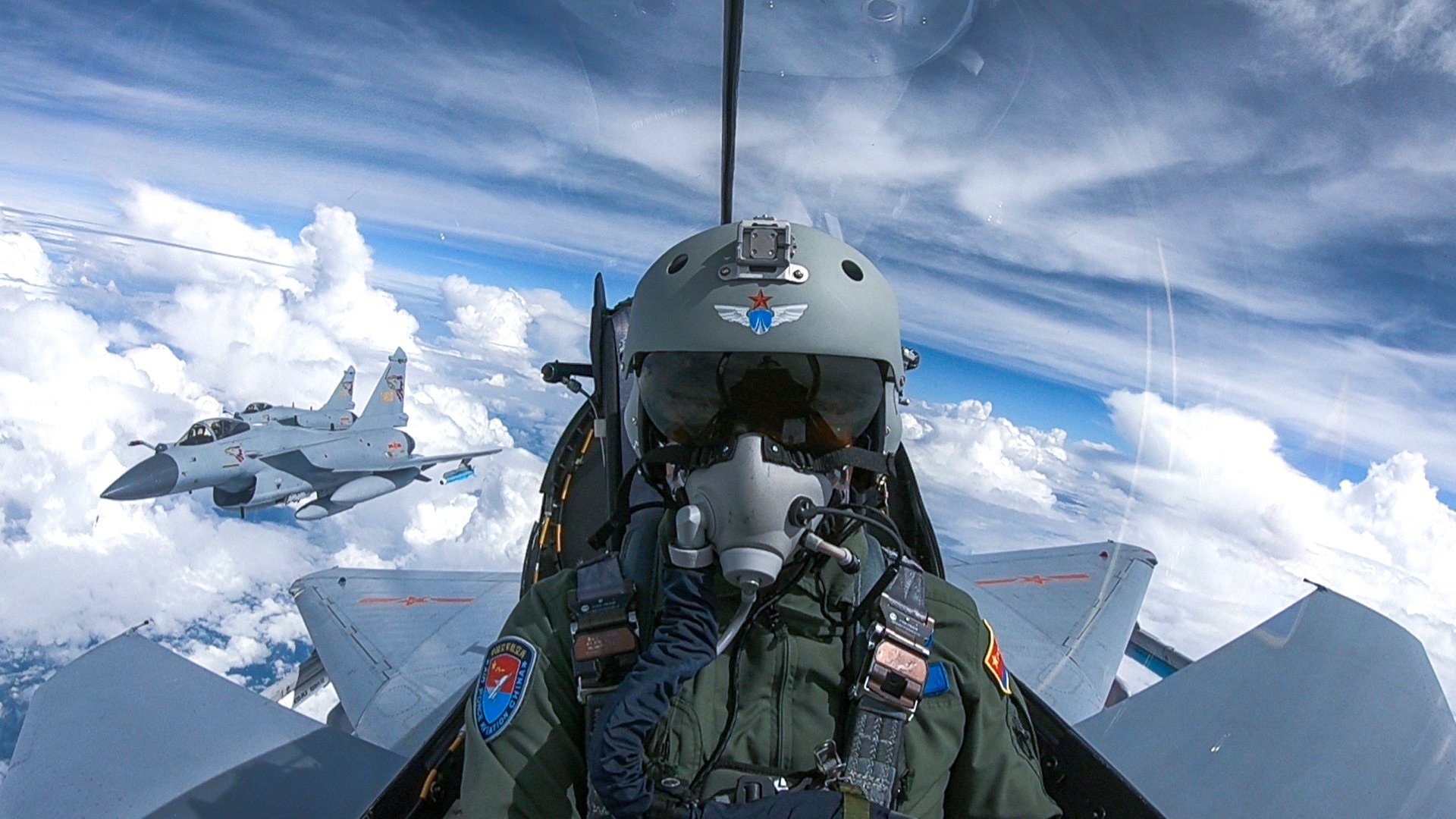 A Chinese pilot navigates his fighter jet over the sky during a joint training exercise.The closing ceremony of the joint exercise code-named "Falcon Strike" between the Chinese People's Liberation Army (PLA) Air Force and the Royal Thai Air Force was held at the Udorn Royal Thai Air Force Base (Udorn RTAFB).