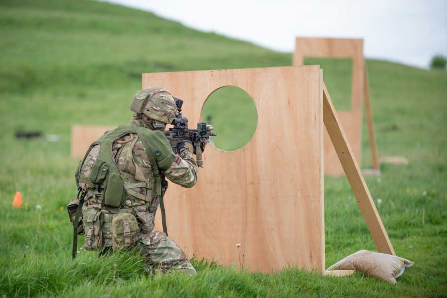Soldier with rifle using a specially designed obstacle course