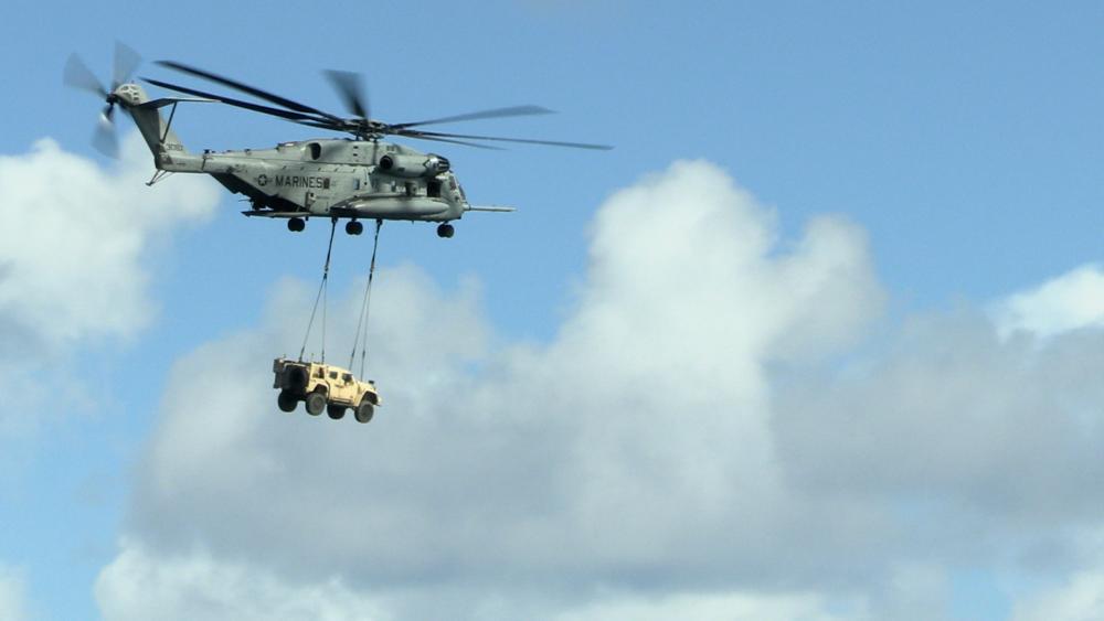 A U.S. Marine CH-53E Super Stallion, with Marine Medium Tiltrotor Squadron 262 (Rein.), 31st Marine Expeditionary Unit, carries a joint light tactical vehicle over the Philippine Sea, Aug. 8, 2022. This exercise proves the 31st MEU can bring heavy equipment to even the most remote locations. 
