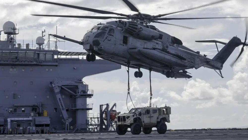 US Marine Corps CH-53E Super Stallion Helicopter Conducts JLTV Shore-To-Ship Heavy Lift