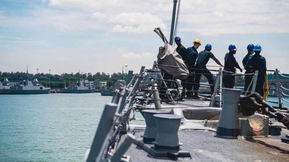  Sailors assigned to the Arleigh Burke-class guided-missile destroyer USS Momsen (DDG 92) raise the jackstaff as the ship pulls into Singapore for a scheduled port visit, Aug. 6. 