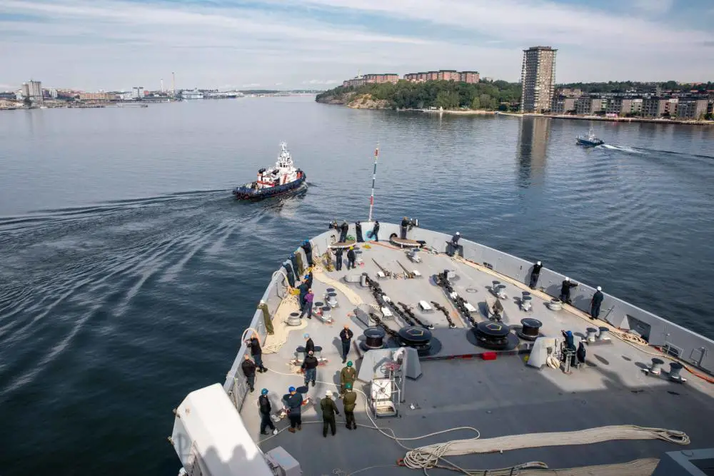 A Swedish tugboat pulls in front of the San Antonio-class amphibious transport dock ship USS Arlington (LPD 24) during a sea and anchor transit to Stockholm, Sweden, Aug. 5, 2022. The Kearsarge Amphibious Ready Group and 22nd Marine Expeditionary Unit, under the command and control of Task Force 61/2, is on a scheduled deployment in the U.S. Naval Forces Europe area of operations, employed by U.S. Sixth Fleet to defend U.S., allied and partner interests. 