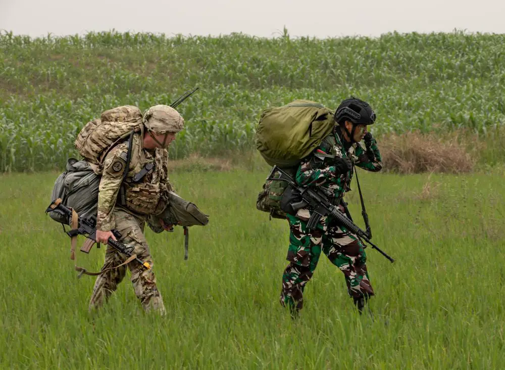 A U.S. Army and Tentara Nasional Indonesia paratroopers march alongside one another during joint airborne operations in support of Super Garuda Airborne on Aug. 3, 2022 in Baturaja, Indonesia. 