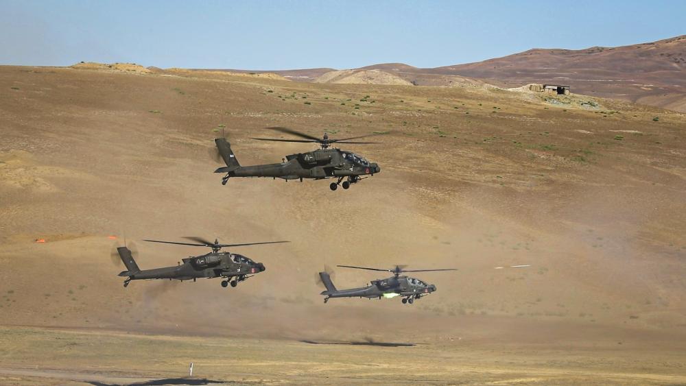 Three U.S. Army AH-64D Apache Longbow helicopters from the 12th Combat Aviation Brigade fire 2.75 folding fin rockets during a combined arms live fire demonstration during Noble Partner 22, at the Vaziani training area in the country of Georgia, Sept. 9, 2022