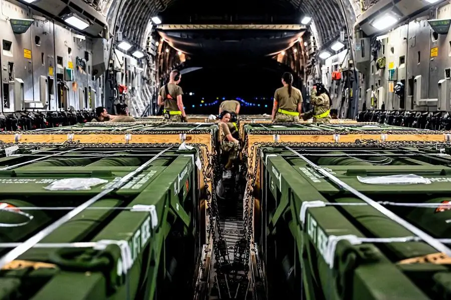 Airmen assigned to the 305th Aerial Port Squadron upload Guided Multiple Launch Rocket System munitions onto a Boeing 767 at Joint Base McGuire-Dix-Lakehurst, N.J., Aug. 13, 2022.