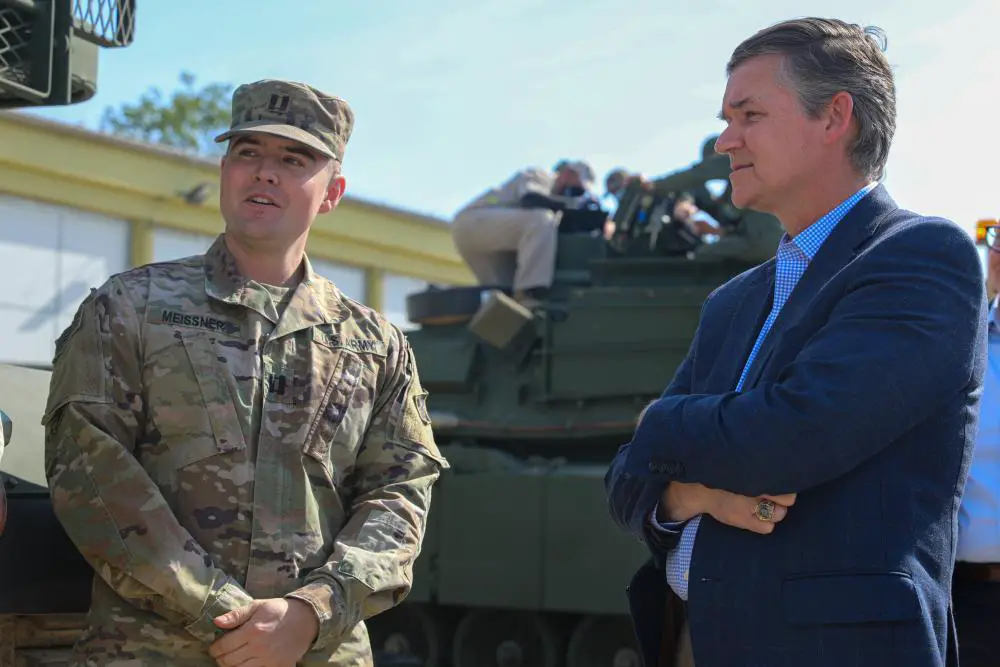 Assistant Secretary of the Army for Acquisition, Logistics and Technology, Douglas R. Bush, right, listens to U.S. Army Capt. Matthew Meissner, company commander of Barbarian Company, 1st Battalion, 68th Armor Regiment, 3rd Armored Brigade Combat Team, 4th Infantry Division, as he presents his Soldiers who are assisting with the Abrams Tank Training Academy at Biedrusko, Poland, Sept. 7, 2022. 