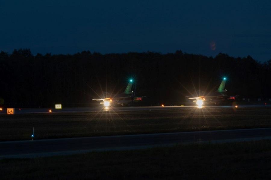 Two Belgian F-16s conducting a night take-off at Ämari Air Base showcasing NATO's collective efforts to safeguard the skies.