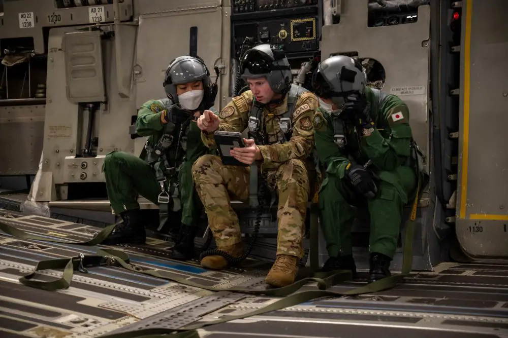 U.S. Air Force Senior Airman Andrew Girard, 535th Airlift Squadron loadmaster, briefs two members of the Japan Air Self-Defense Force (Koku-Jieitai) during a training exercise around the Hawaiian Islands, Sept. 27, 2022. 