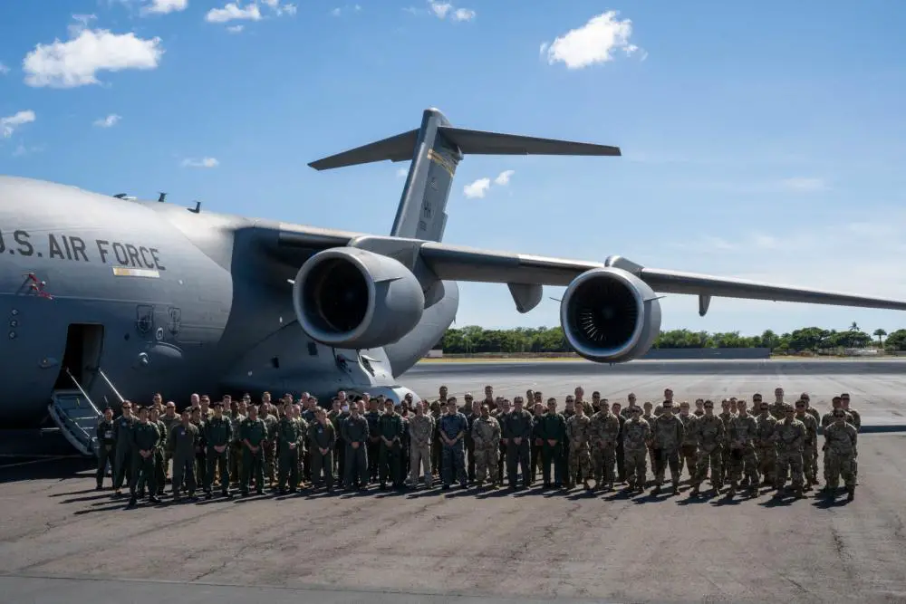 Members from the U.S. Air Force 535th Airlift Squadron and the Japan Air Self-Defense Force 403rd Tactical Airlift Squadron pose for a photo after a flight during a bilateral training exercise around the Hawaiian Islands, Sept. 27, 2022. 