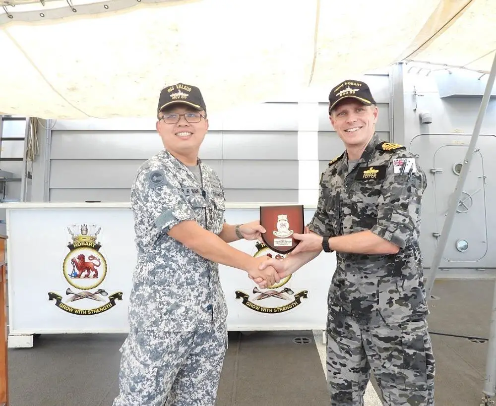 LTC Huang Zongren of RSS Valour and Commander Andrew Pepper of HMAS Hobart exchanging a plaque during the opening ceremony.