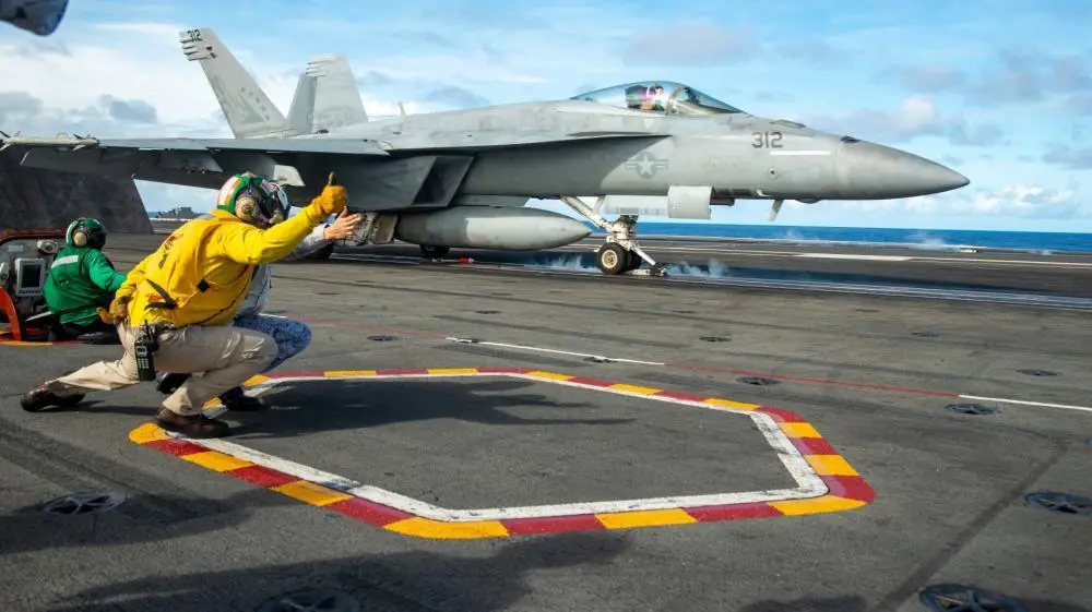 Lt. Cmdr. Adam Lang, from Lascassas, Tennessee, shows a Philippine navy sailor how to launch an F/A-18E Super Hornet, attached to the Eagles of Strike Fighter Squadron (VFA) 115, on the flight deck aboard the U.S. Navy’s only forward-deployed aircraft carrier, USS Ronald Reagan (CVN 76), in the Philippine Sea, October 14.