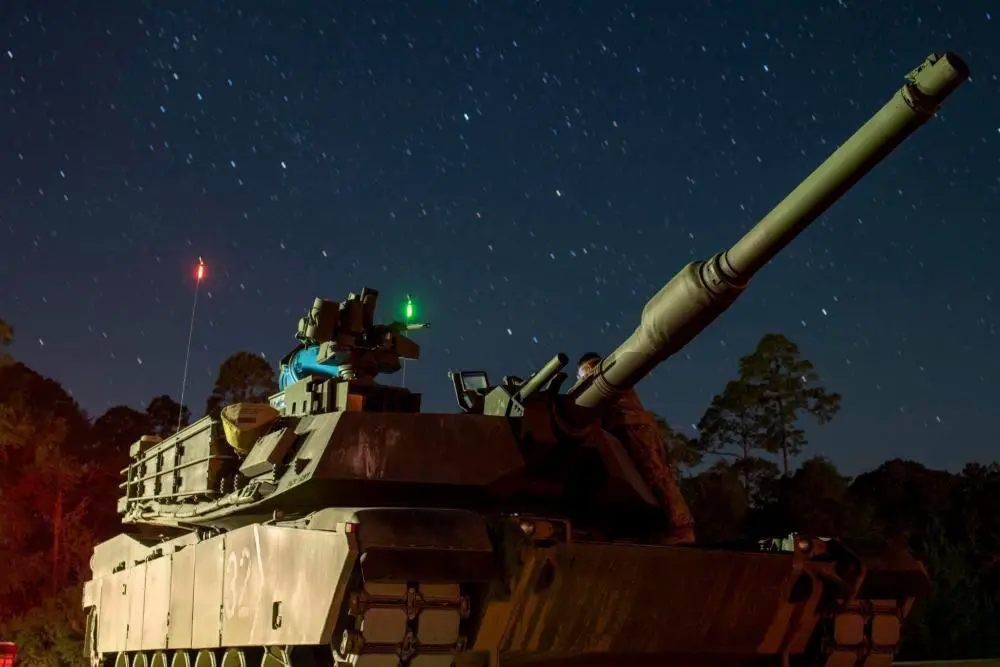 A modernized M1A2 SEPv3 Abrams tank assigned to Bravo Company, 2nd Battalion, 69th Armor Regiment, 2nd Armored Brigade Combat Team, waits in line for night Table VI operator new equipment training at Fort Stewart, Georgia, Sept. 24, 2022.