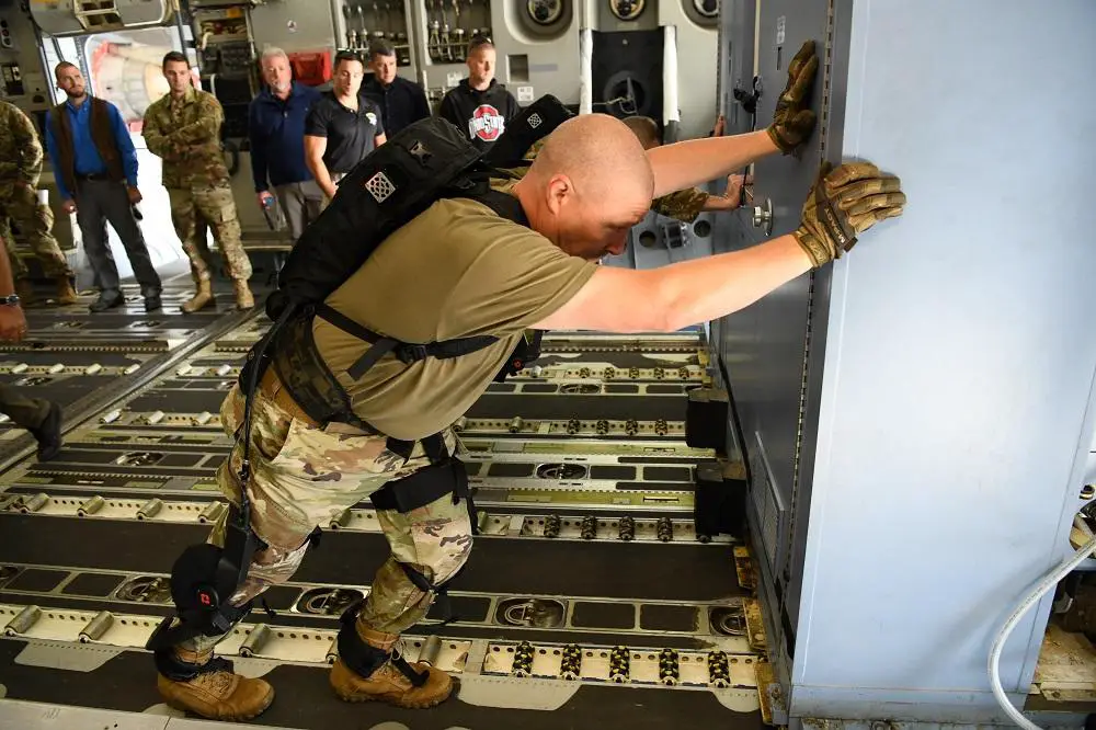 Chief Master Sgt. Sean Storms, 445th Airlift Wing aerial port manager, pushes oversized cargo across the floor of a C-17 Globemaster III during an Air Force Research Laboratory demonstration of a pneumatically-powered exoskeleton system at Wright-Patterson Air Force Base, Ohio, Oct. 6, 2022. (U.S. Air Force photo by Patrick O’Reilly)