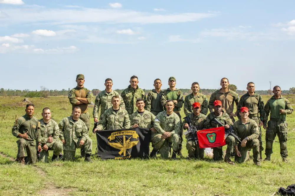 Marines from Brazil and Uruguay pose for a photo after conducting a static line parachute training from a UH-1Y Venom helicopter with Marine Light Attack Helicopter Squadron (HMLA) 773, 4th Marine Aircraft Wing, Marine Forces Reserve in support of Special Purpose Marine Air-Ground Task Force UNITAS LXIII, at Santa Cruz Air Force Base, Rio de Janeiro, Sept. 6, 2022. 