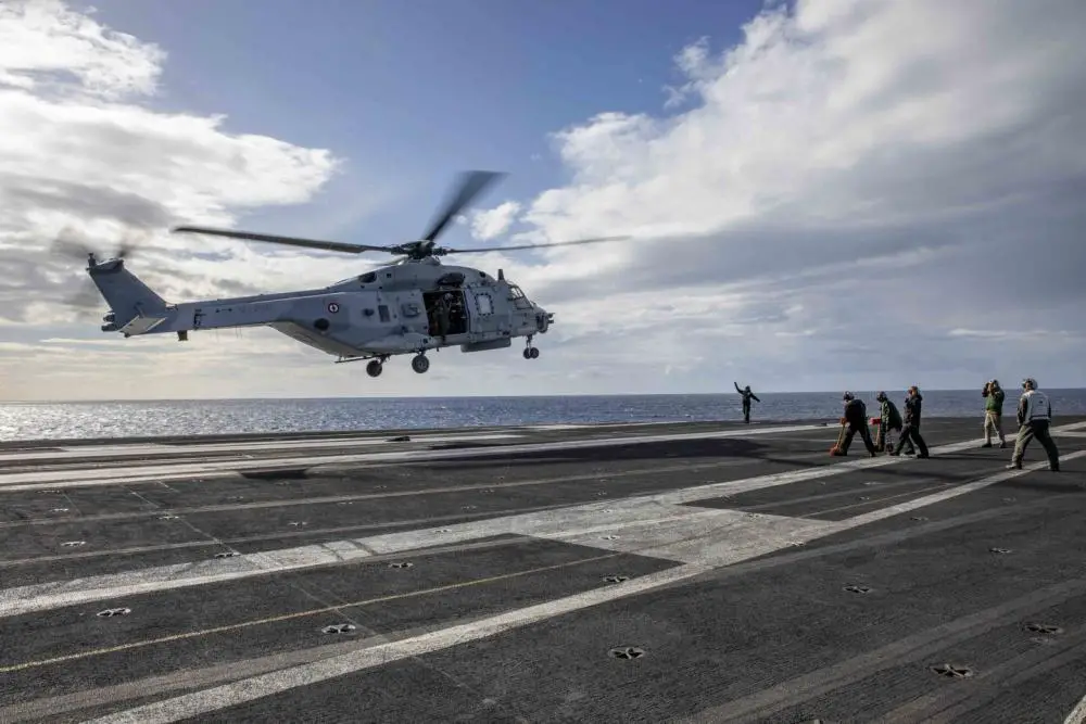 A French EH-101 helicopter, attached to the French Carrier Strike Group, lands on the flight deck of the Nimitz-class aircraft carrier USS George H.W. Bush (CVN 77) during multicarrier operations, Nov. 23, 2022. 