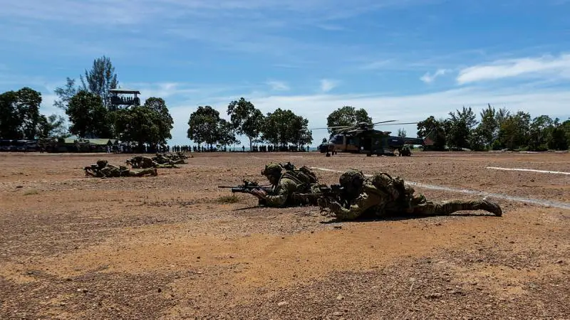Australian Army and TNI Marines respond to an air assault during a beach demonstration in Indonesia.