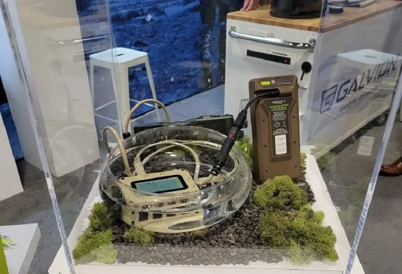 Squad Power Manager (SPM), submerged in water, with new SoloPack II 140Wh rechargeable battery and radio on  display at AUSA 2022.
