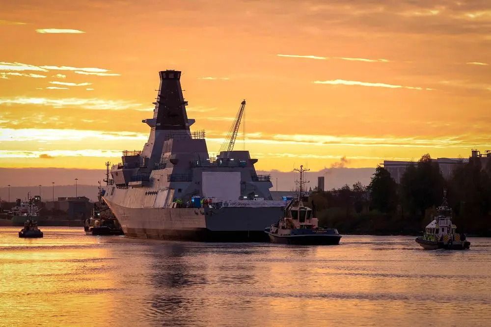 Royal Navy Type 26 Frigate HMS Glasgow (F88) being towed and maneuvered alongside at BAE Systems Scotstoun on the Clyde. 