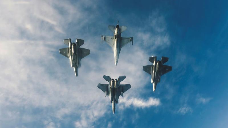 RAAF F-35A Lightning II and RSAF, F-16 Fighting Falcon and F-15SG Strike Eagle aircraft fly in formation over Singapore.