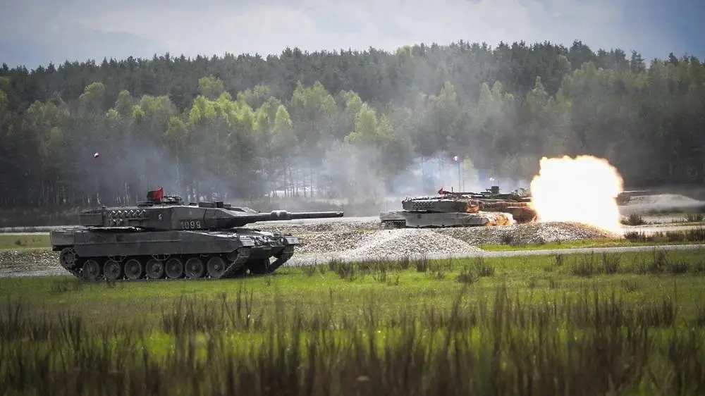 A Polish Leopard 2A5 tank fires at its target during the Strong Europe Tank Challenge (SETC), at the 7th Army Training Command Grafenwoehr Training Area, Grafenwoehr, Germany,