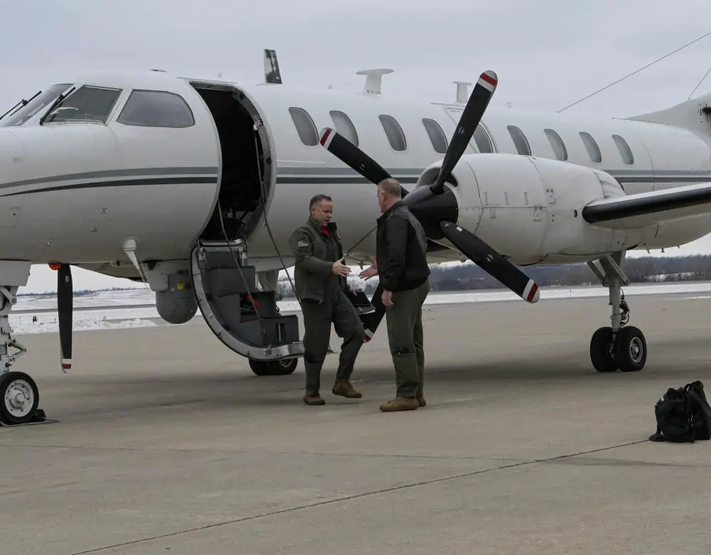 Col. Travis Crawmer, 132d Wing commander, greets Lt. Col. Caleb Ramsey, RC-26 program director, following the completion of the aircraft’s final mission January 27, 2023, at the 132d Wing in Des Moines, Iowa. 