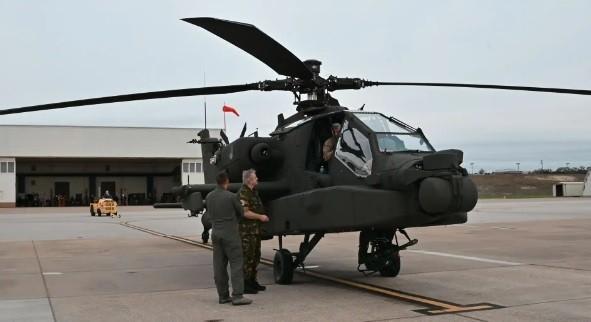 Members of the 302nd Squadron of the Royal Netherlands Air Force look over one of two new AH-64E Apache Guardian attack helicopters delivered to their squadron on Robert Gray Army Airfield at Fort Hood, Texas, Dec. 13. 