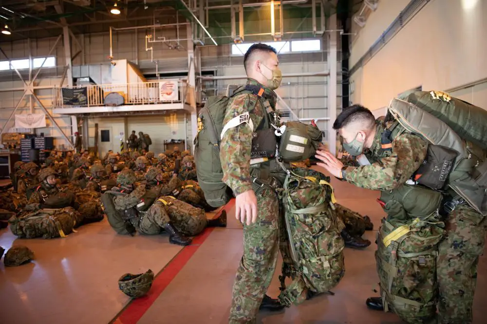 Japan Ground Self-Defense Force paratroopers with the 1st Airborne Brigade don their gear for the annual New Year’s Jump event at Yokota Air Base, Japan, Jan. 8, 2023.