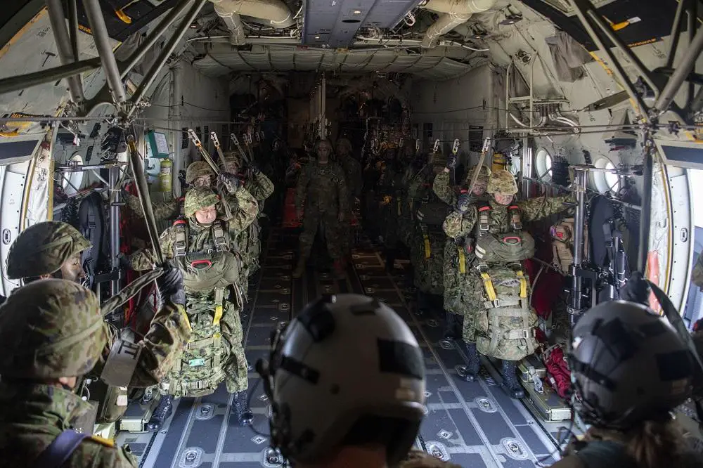 Japan Ground Self-Defense Force paratroopers from the 1st Airborne Brigade, hook up to the static line inside of a 36th Airlift Squadron C-130J Hercules before jumping out of the aircraft over a Camp Narashino training area Chiba, Japan, Jan. 8, 2023. 