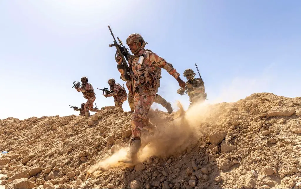Image shows Omani soldiers as they attack a simulated village as part of Exercise Khanjar Oman.
