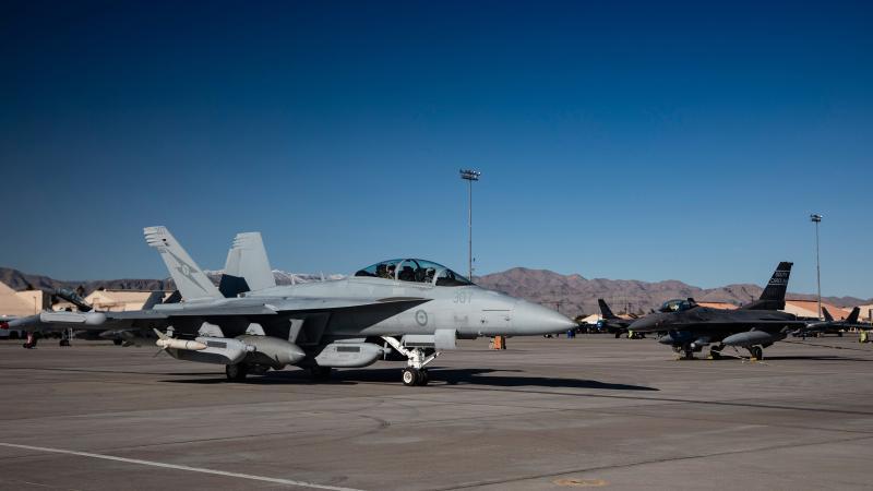 A Royal Australian Air Force EA-18G Growler taxis past a United States Air Force F-16 Falcon at Nellis Air Force Base, Nevada, during Exercise Red Flag 23-1. Photo: Air Specialist (Class 1) Samantha Holden, Royal Air Force.