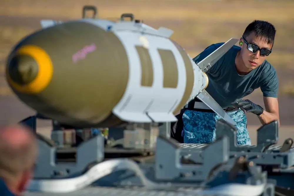 A Republic of Singapore Airman, assigned to the 428th Fighter Squadron, guides a GBU-12 Pavewayy II bomb at Luke Air Force Base, Ariz., Dec. 2, 2017. The 428th FS, from Mountain Home Air Force Base, Idaho, participated in Exercise Forging Sabre that included dropping live munitions at the Barry M. Goldwater Range complex.