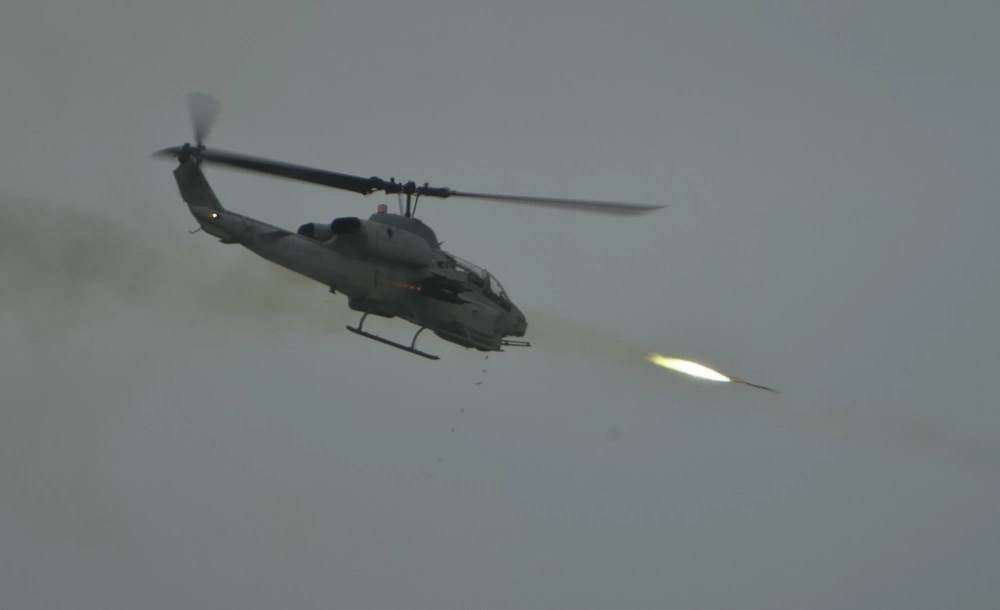 A U.S. Marine Corps AH-1W Super Cobra assigned to Marine Aviation Weapons and Tactics Squadron One (MAWTS-1) fires rockets during an evolution at Mt. Barrow, Chocolate Mountain Aerial Gunnery Range, Calif