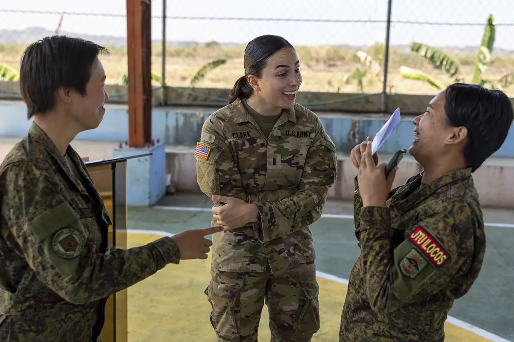 Philippine and U.S. soldiers discuss the future construction of a new community health care center in preparation for exercise Balikatan 23 in Ilocos Norte, the Philippines, March 27, 2023.
