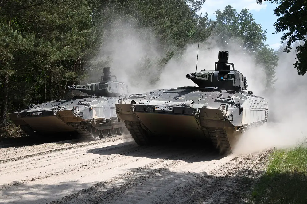 Two PUMA infantry fighting vehicles at full speed on the training grounds in Munster.