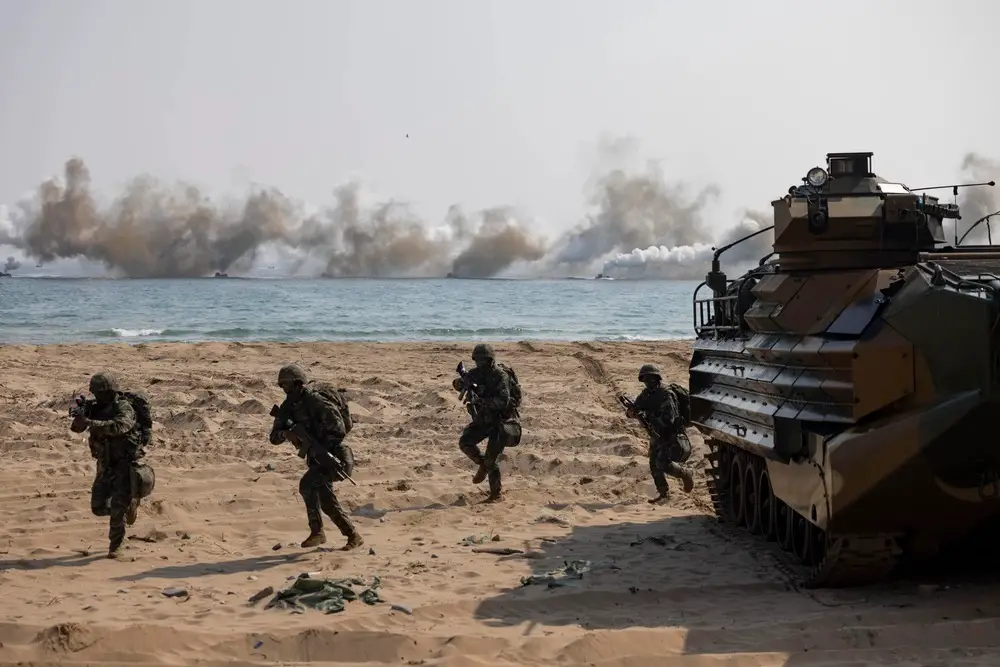 Republic of Korea Marines move up a beach while conducting an amphibious assault exercise during Ssang Young 23. 