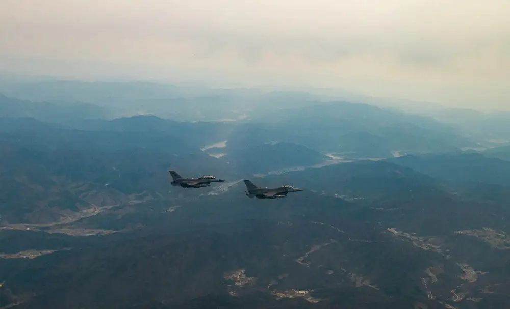 Two F-16 Fighting Falcons assigned to the 8th Fighter Wing, Kunsan Air Base, Republic of Korea, fly over the Korean Peninsula, April 4, 2023. The F-16 Fighting Falcon is a highly maneuverable, multi-role fighter aircraft that provides a relatively low-cost, high-performance weapon system for the United States and allied nations. The Air Force Life Cycle Management Center has provided the F-16 fleet various modifications and upgrades since entering the Air Force inventory in 1979. The Post Block Integration Team (PoBIT) project is the most recent large-scale upgrade to the F-16, encompassing 22 combined modifications that increase survivability and accuracy of the weapon system. (U.S. Air Force photo by Captain Kaylin P. Hankerson)

