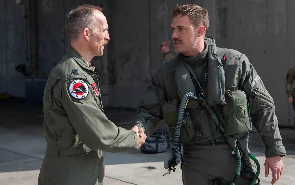  U.S. Air Force Lt. Col. Shaun Loomis, 480th Expeditionary Fighter Squadron commander, left, shakes hands with U.S. Air Force Lt. Col. Michael Mickus, 355th Expeditionary Fighter Squadron commander, at Kadena Air Base, Japan, March 28, 2023. 