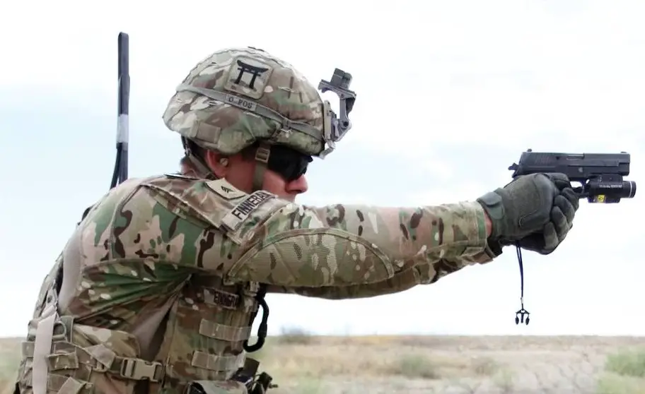 Sgt. Andrew Finneran, a 101st Airborne Division infantryman, fires a Sig Sauer pistol during partnered weapons training May 29, 2015 at Tactical Base Gamberi in eastern Afghanistan. 