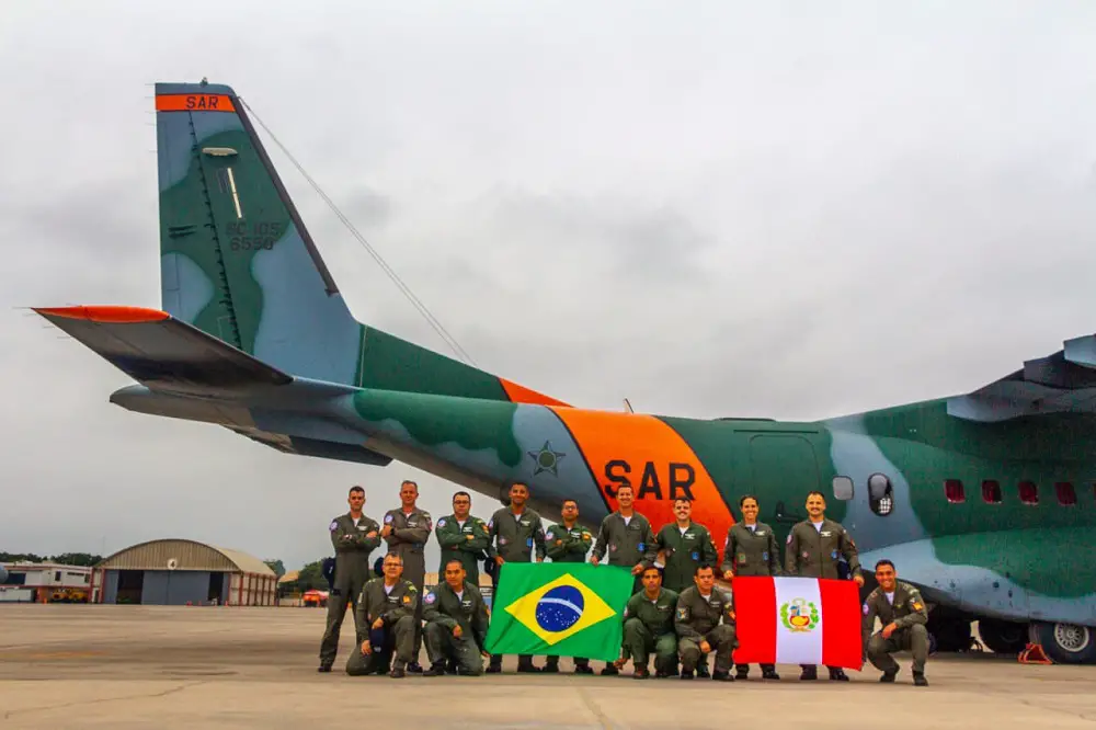 Brazilian and Peruvian air force personnel pose in front of the Embraer KC-390 transport aircraft after landing at the aerodrome in Jauja, Peru