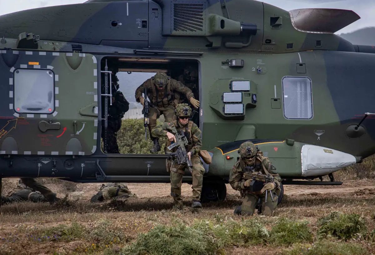 During exercise Noble Jump 23, Norwegian soldiers exit the German NH-90 transport helicopter after landing and immediately go to safety.