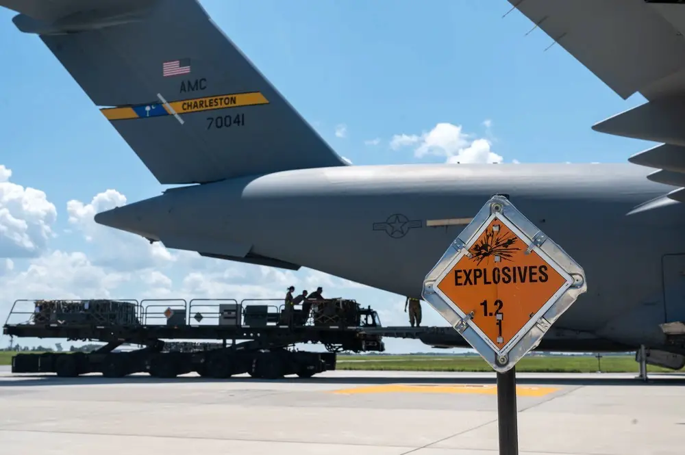 An explosives sign marks the cordon around a C-17 Globemaster III during a security assistance mission at Dover Air Force Base, Delaware. The Department of Defense is providing Ukraine with critical capabilities to defend against Russian aggression under the Ukraine Security Assistance Initiative.