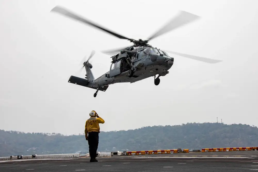 A U.S. Navy MH-60S Sea Hawk assigned to Helicopter Sea Combat Squadron 21 takes off from the flight deck of amphibious assault ship USS Makin Island (LHD 8), during Balikatan 23, April 12, 2023 in the Subic Bay Harbor.