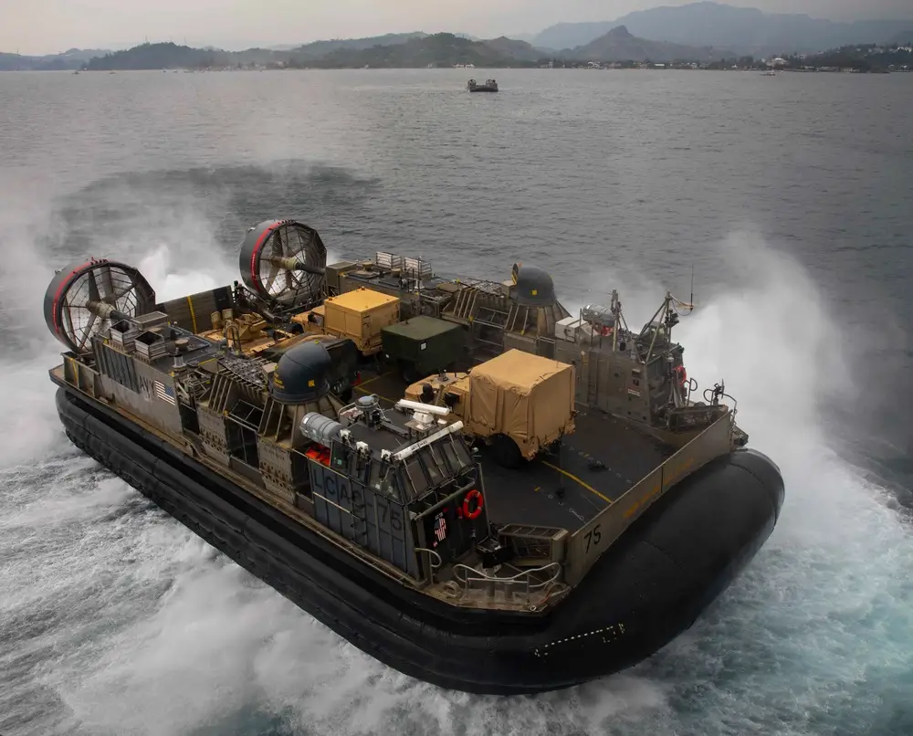 A U.S. Navy landing craft, air cushion, assigned to Assault Craft Unit 5, departs the well deck of amphibious assault ship USS Makin Island (LHD 8), during Balikatan 23, April 12, 2023 in the Subic Bay Harbor.